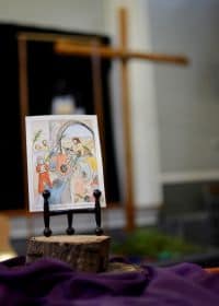 Artwork by Luz Frye of Jesus entering Jerusalem on a donkey. 