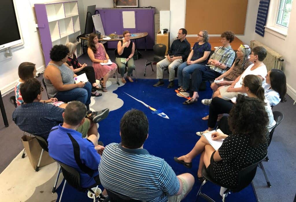 Group sitting in chairs in a circle.