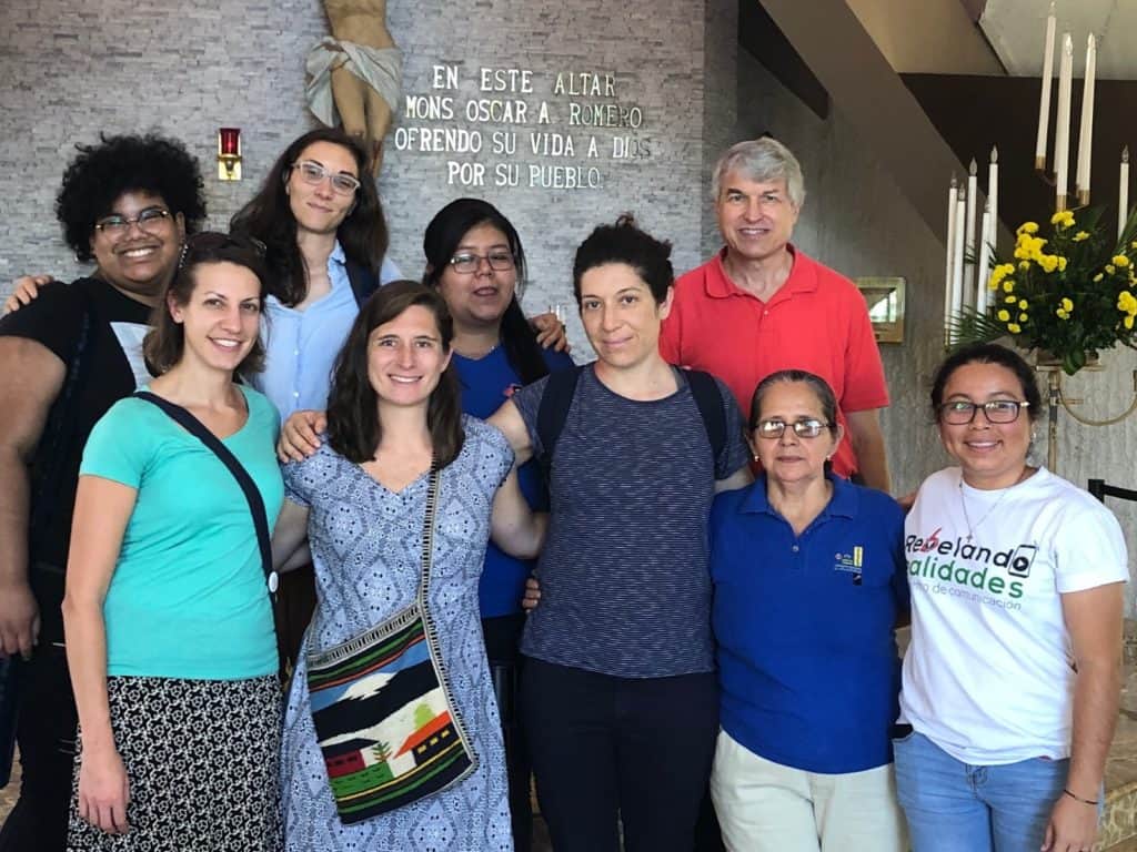Group photo of those who traveled to El Salvador, along with two of the hosts, in the chapel dedicated to Oscar Romero.