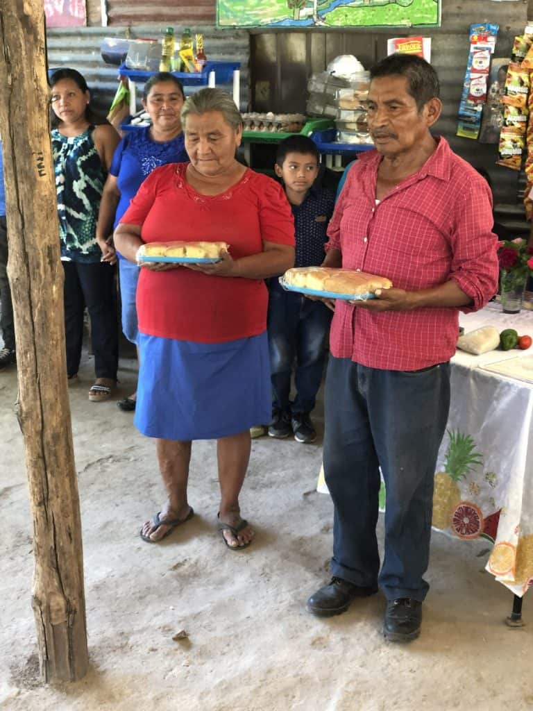 Two people sharing unique communion elements in El Salvador.