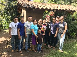 Group photo with house in background: Show Angel and Melissa with the nine individuals who hosted them in Colón, El Salvador 