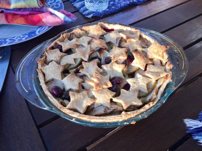 An apple cranberry pie with a star-shaped crust.
