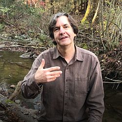 Steve Derthick portraying John the Baptist in front of a babbling creek.