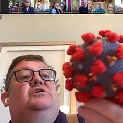 Tripp holding a croqueted replica of the Covid-19 virus while preaching.