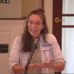 Melissa preaching at RMC, Aug. 15, 2021, with her hands reaching out.