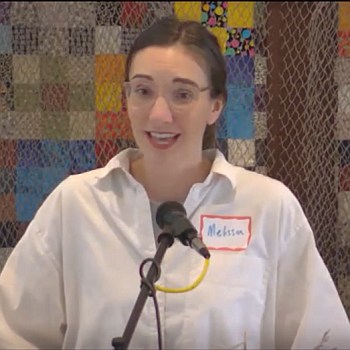 Melissa preaching at Raleigh Mennonite in front of a quilted wall hanging.