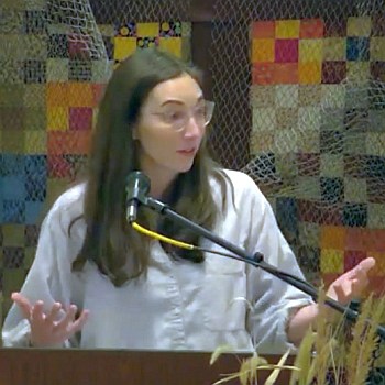 Melissa preaching at RMC on March 12, 2023 in front of a quilted wall hanging.