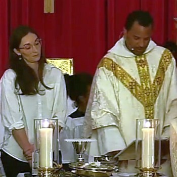 Father Jemonde Taylor and Pastor Melissa prepare communion at St. Ambrose Church