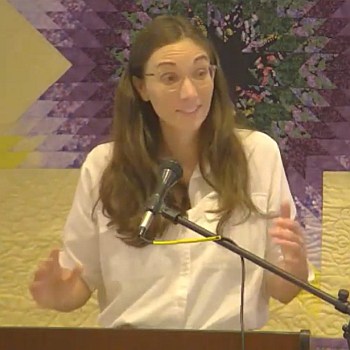 Melissa, holding her hands out while preaching on Dec. 3, 2023.
