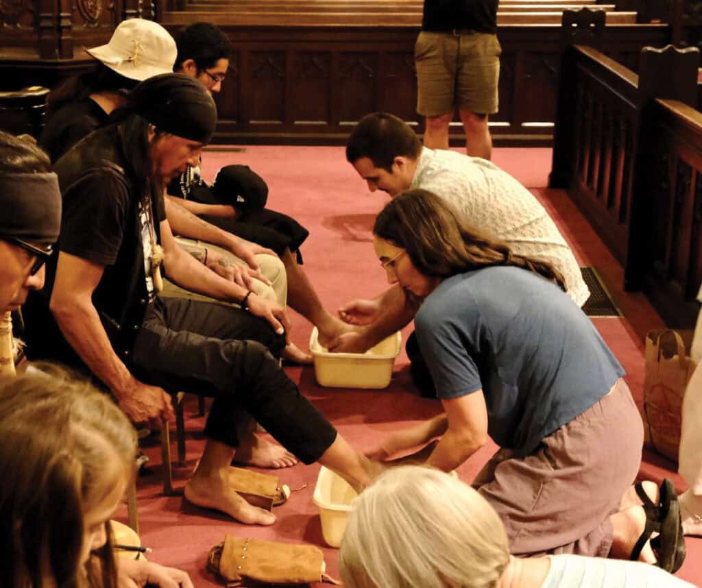 Woman and man washing the feet of those who are marching to Washington DC to petition the Supreme Court.