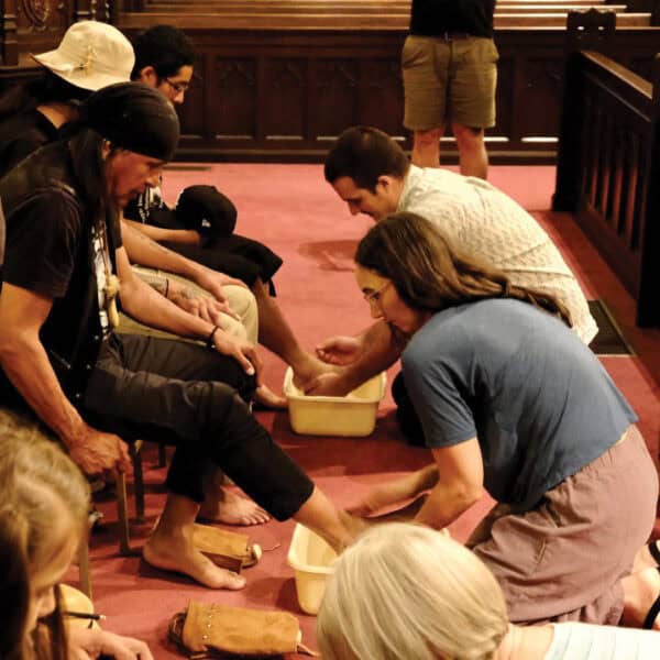 Woman and man washing the feet of those who are marching to Washington DC to petition the Supreme Court.