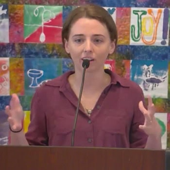 Katie holding her hands out expressing a point in her sermon at Raleigh Mennonite on July 13, 2025
