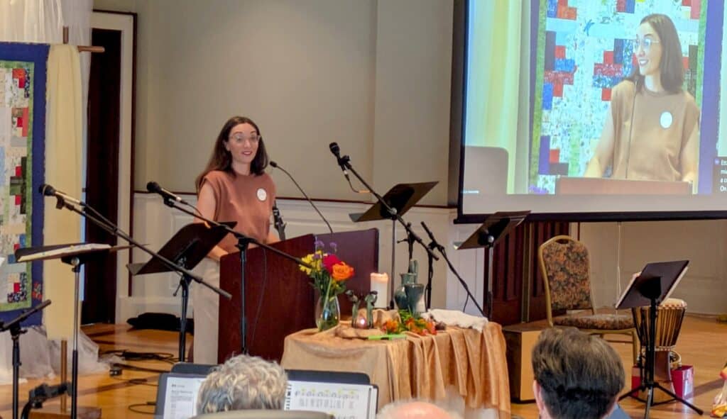 Melissa preaches her final sermon at RMC with her image projected on the screen beside her.