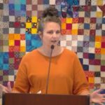 Melissa Rogati speaking at RMC in front of a colorful quilt on Sept. 14, 2025