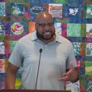 Trey preaching at RMC on Aug. 9, 2026, with one hand gesturing to make his point.