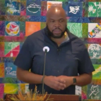 Trey preaching at RMC in a dark blue shirt on Oct. 25, 2026